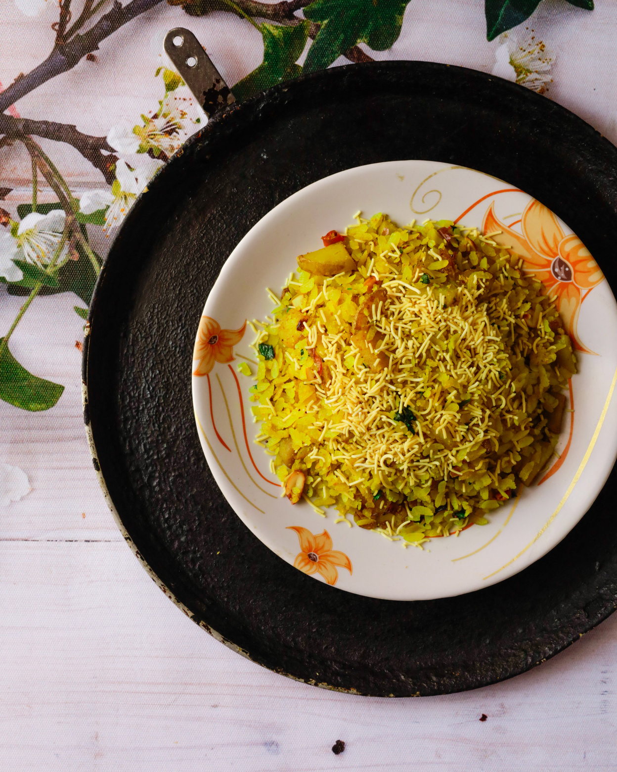 Indian breakfast dish poha on white wooden background photo